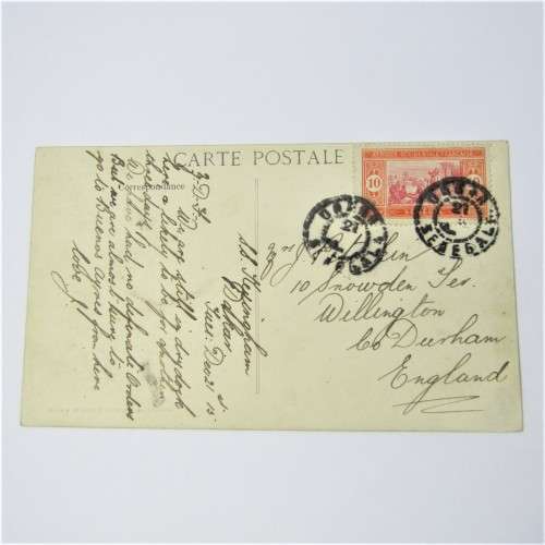 Senegal postcard to England with a Senegal stamp and two unclear cancellations
