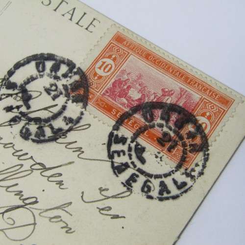 Senegal postcard to England with a Senegal stamp and two unclear cancellations