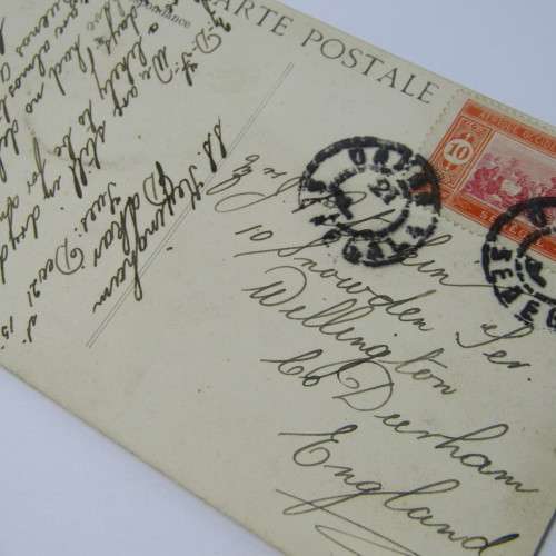 Senegal postcard to England with a Senegal stamp and two unclear cancellations