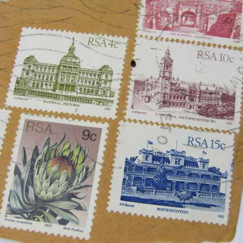 Lot of South African building stamps and others on piece with airmail