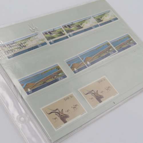Lot of 9 folders with more than 200 SWA mint stamps