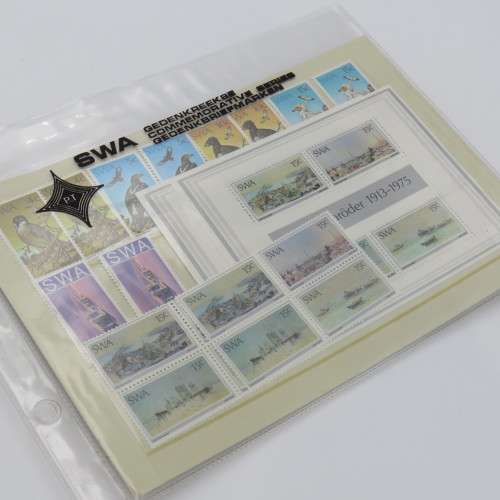 Lot of 9 folders with more than 200 SWA mint stamps