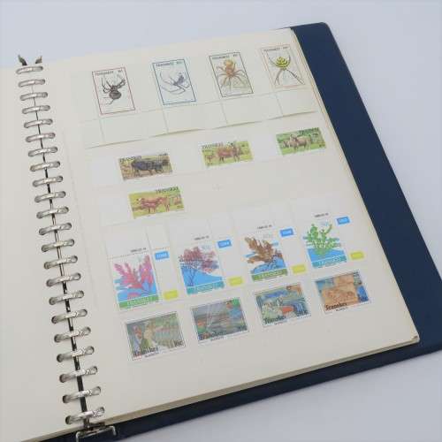 Album with over 1100 stamps including Transkei and Venda mint collections and a lot of USA stamps