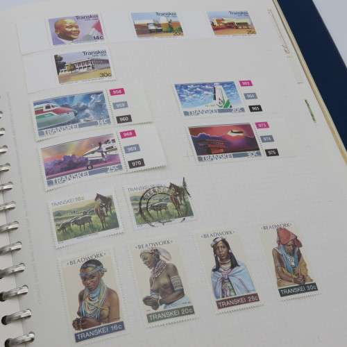 Album with over 1100 stamps including Transkei and Venda mint collections and a lot of USA stamps