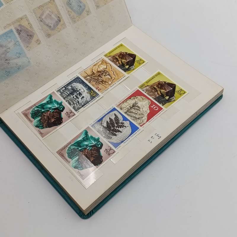 Lot of 92 mostly mint stamps with fossils & minerals - in 14 page small album