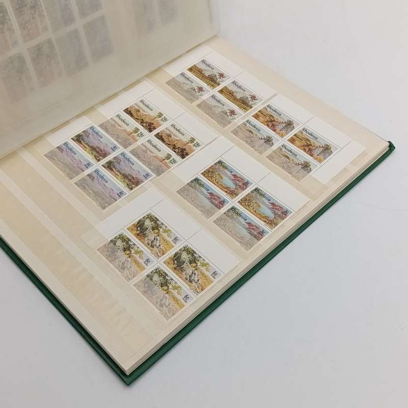 16 page stamp album with about 180 Rhodesia mint stamps