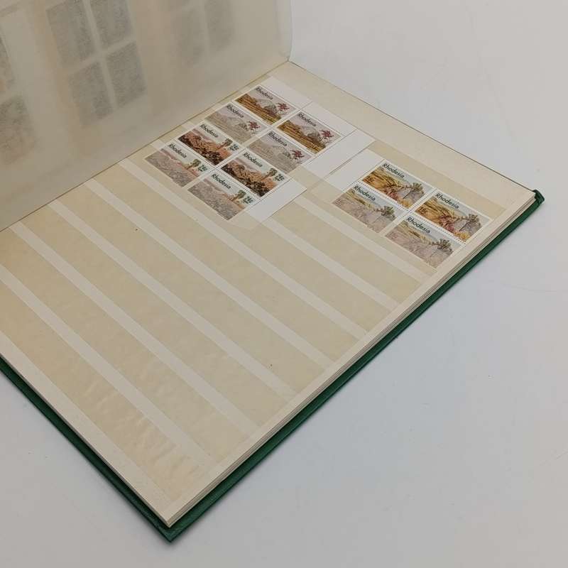 16 page stamp album with about 180 Rhodesia mint stamps