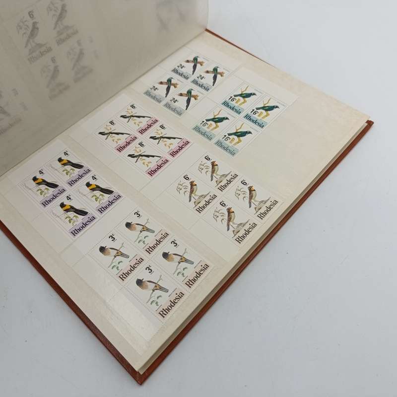 16 page album with over 450 Rhodesia mint stamps