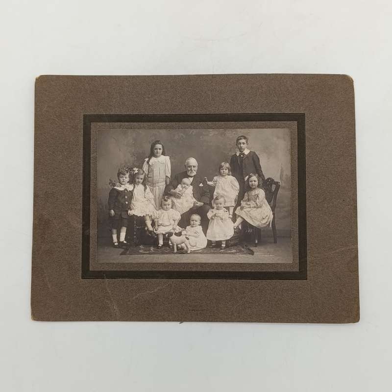 Antique photo of a Grandfather with 11 grandchildren
