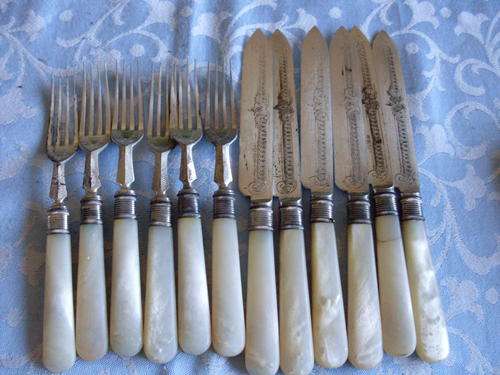 Elegant Fish knife & fork set with mother of pearl handles. One knife has fine hair crack.