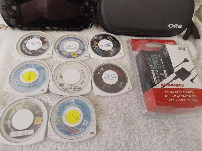 PSP 1000,  Charger, 5UMD Games + 2 UMD Music videos loose + Carry case (512mb Memory Card)
