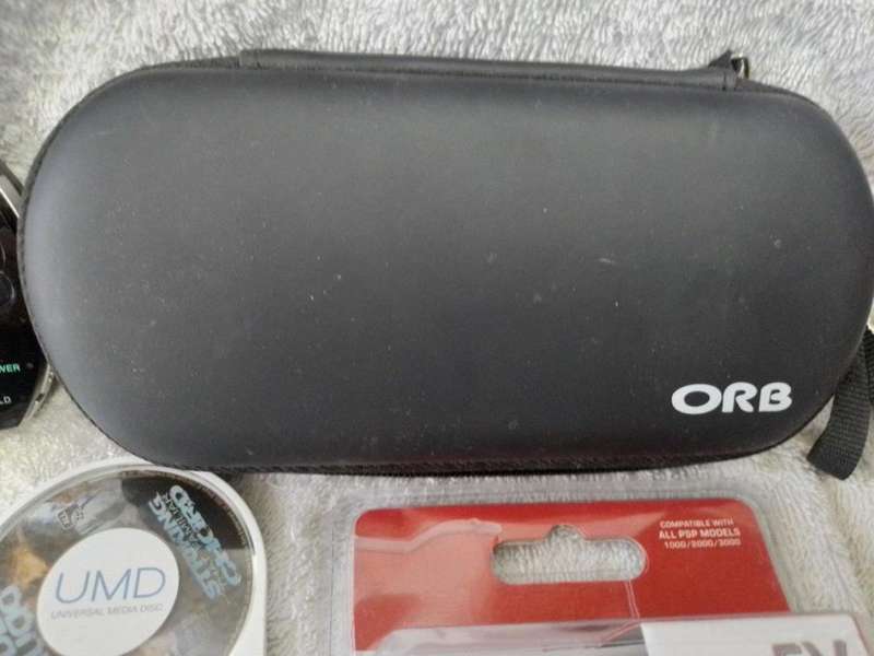 PSP 1000,  Charger, 5UMD Games + 2 UMD Music videos loose + Carry case (512mb Memory Card)