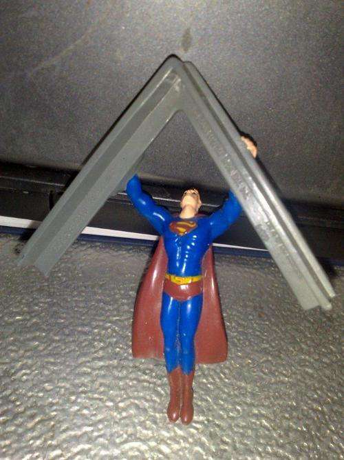 Superman flying with a girder static figue