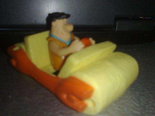 Fred Flintstone in his car