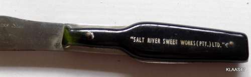STAINLESS STEEL CHEESE KNIFE - BOTTLE SHAPED HANDLE - `SALT RIVER SWEET WORKS (PTY) LTD`