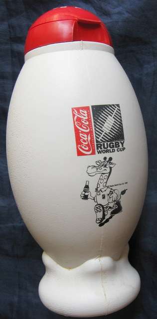 1995 : RUGBY WORLD CUP : SPUR RUGBY RAVE & COCA-COLA : PLASTIC RUGBY BALL SHAPED BOTTLE : 23cm HIGH