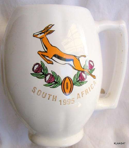 BEER MUG : RUGBY BALL SHAPE : 1995 WORLD CUP - SOUTH AFRICA : 13cm HIGH - 6.5cm TOP DIAM