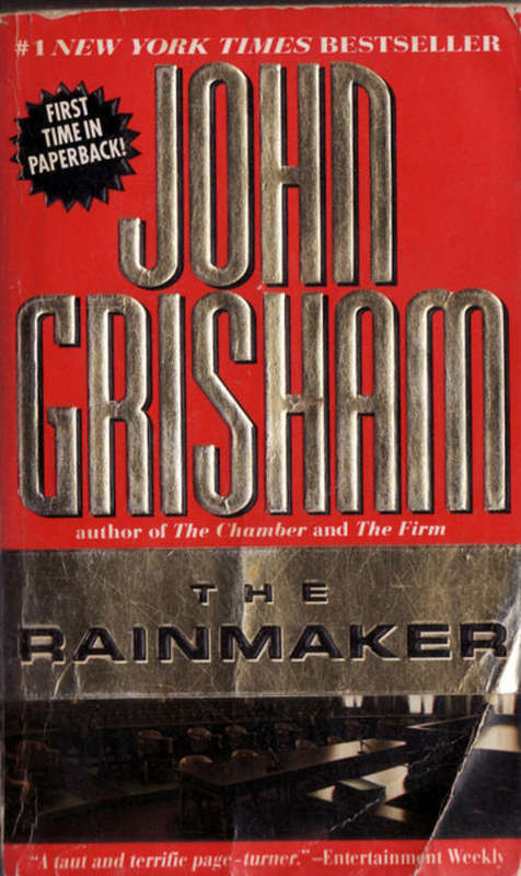 THE  RAINMAKER BY JOHN CRISHAM  PAPERBACK   BOOK HAS GONE BROWN