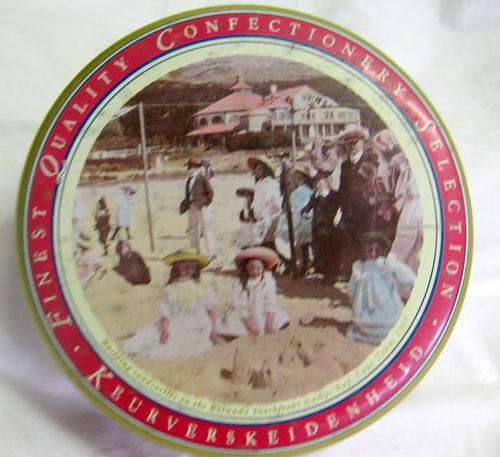 CONFECTIONERY TIN : 18cm DIAMETER : 6cm DEEP : ROTUNDA BEACHFRONT CAMPS BAY CAPE TOWN.