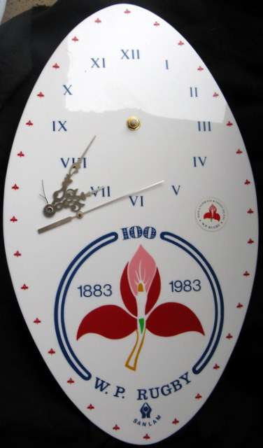 W.P RUGBY - 1883 - 1983 : PERSPEX CLOCK RUGBY BALL SHAPE - 44.5x25.7cm : **WORKING**