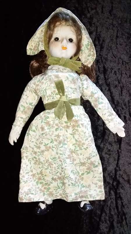 Collectors Doll-Not Marked. Orange flowers and green vines and leaves. Painted on shoes.