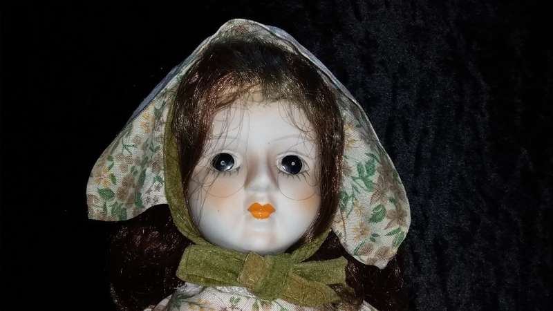 Collectors Doll-Not Marked. Orange flowers and green vines and leaves. Painted on shoes.