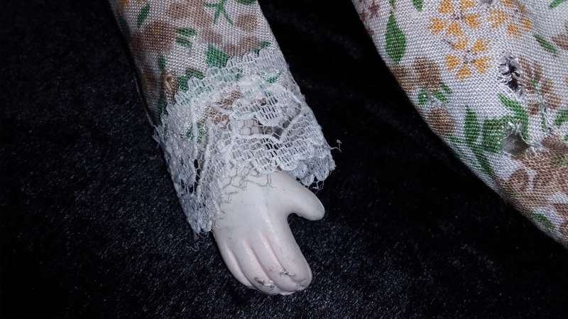 Collectors Doll-Not Marked. Orange flowers and green vines and leaves. Painted on shoes.