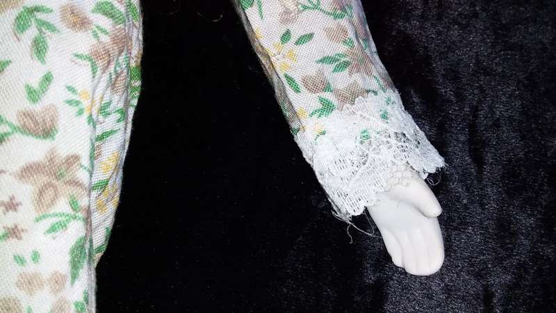 Collectors Doll-Not Marked. Orange flowers and green vines and leaves. Painted on shoes.