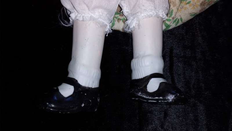 Collectors Doll-Not Marked. Orange flowers and green vines and leaves. Painted on shoes.