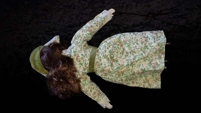 Collectors Doll-Not Marked. Orange flowers and green vines and leaves. Painted on shoes.