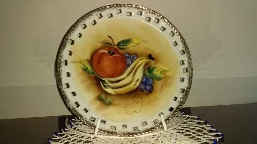Vintage pierced rim display plate with painted fruit on.
