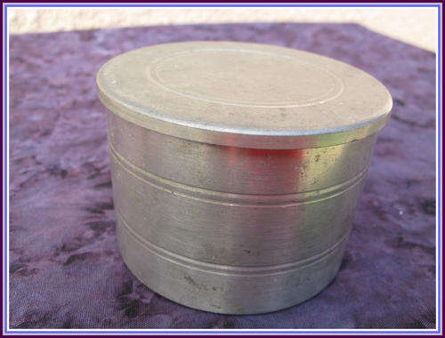 Pewter tea caddy with glass container inside.