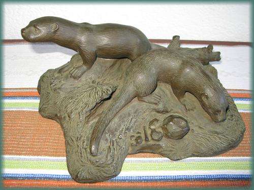 A bronze sculpture of 2 otters feeding. Signed by C. V. le Sueur