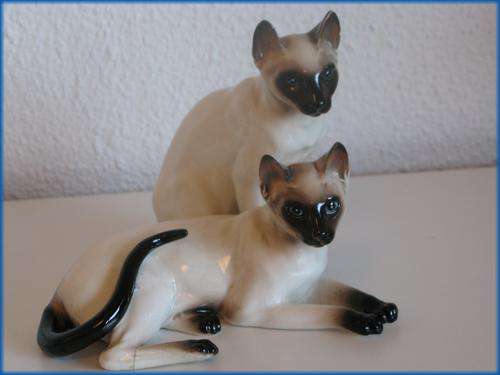 A pair of vintage siamese porcelain cats.