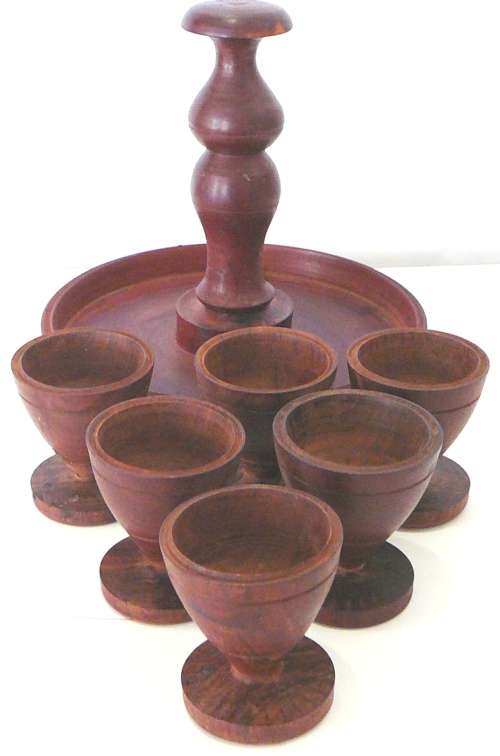 A Set of 6 Hand Turned Wooden Egg Cups on a Stand