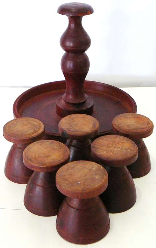 A Set of 6 Hand Turned Wooden Egg Cups on a Stand