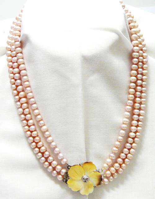 A Beautiful 3 Strand Real Pink Pearl Necklace with Mother of Pearl Clasp.