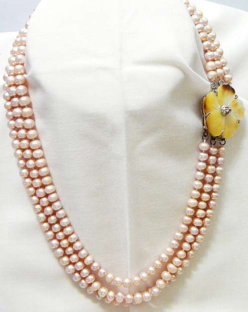 A Beautiful 3 Strand Real Pink Pearl Necklace with Mother of Pearl Clasp.