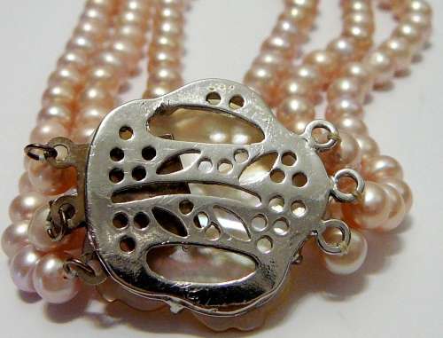 A Beautiful 3 Strand Real Pink Pearl Necklace with Mother of Pearl Clasp.