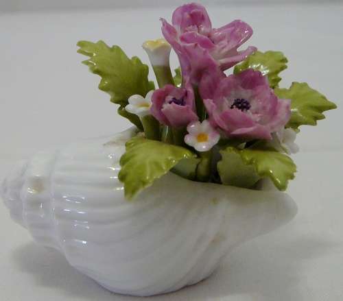 Gorgeous delicate Porcelain Pink Flowers in a White Snail Shell