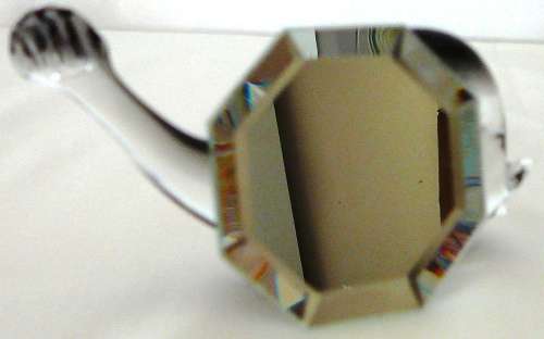 A Murano Glass Whale resting on an Octagonal Mirror