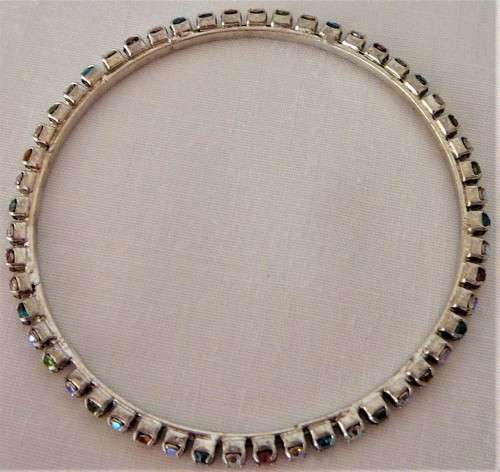 A Multi Coloured Diamante Bangle set into Silver Coloured Metal