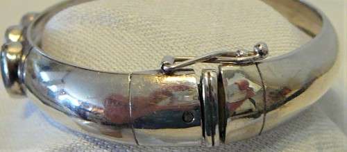A Very Tasteful Sterling Silver Bangle set with a White Opal & 2 Precious Opals