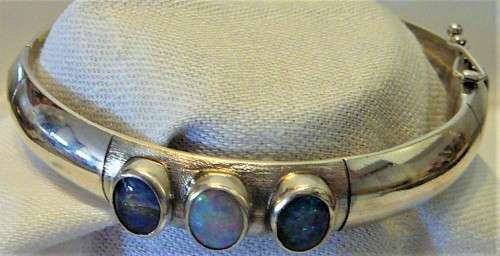 A Very Tasteful Sterling Silver Bangle set with a White Opal & 2 Precious Opals