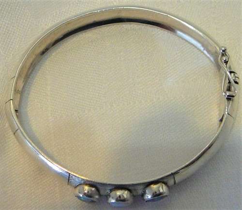 A Very Tasteful Sterling Silver Bangle set with a White Opal & 2 Precious Opals