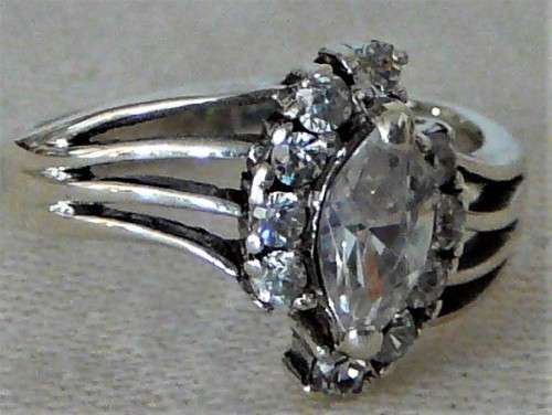 A Sterling Silver Ring set with an Oval CZ and 10 Smaller CZ's