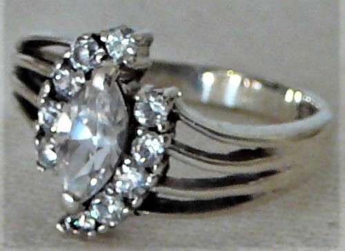 A Sterling Silver Ring set with an Oval CZ and 10 Smaller CZ's