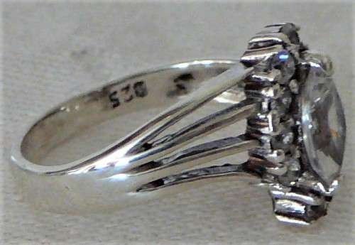 A Sterling Silver Ring set with an Oval CZ and 10 Smaller CZ's