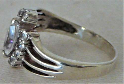 A Sterling Silver Ring set with an Oval CZ and 10 Smaller CZ's