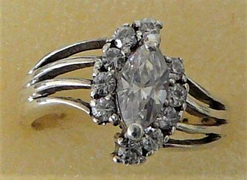 A Sterling Silver Ring set with an Oval CZ and 10 Smaller CZ's